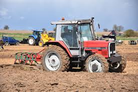 3000 series Massey Ferguson pulling a plough in a field